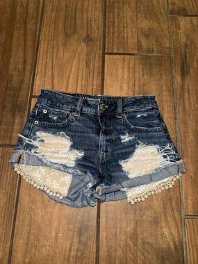 American Eagle hi-rise festival denim shorts featuring lace crochet pocket